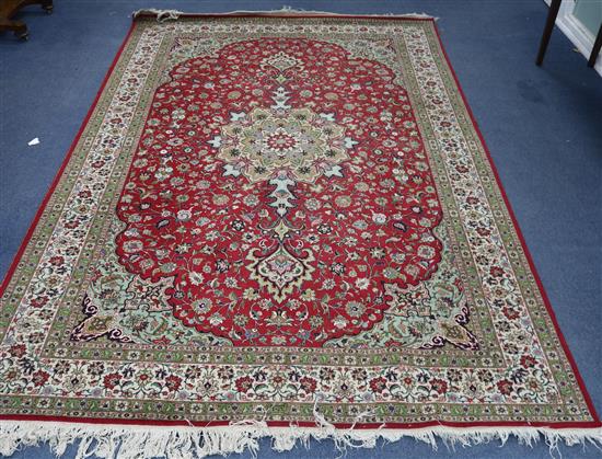 A small red ground rug 300 x 200cm